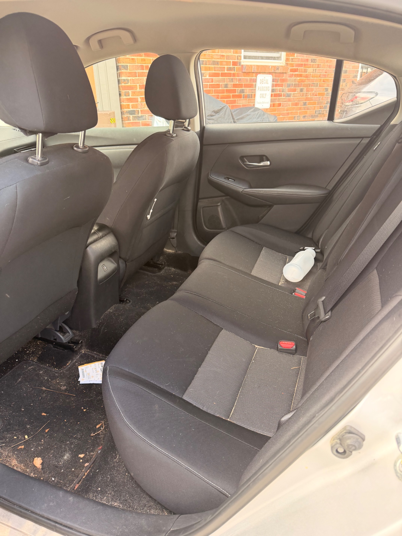 Car floor mats covered in dirt and debris before detailing